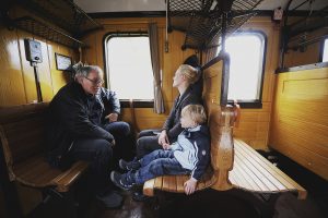 Passengers enjoy the historic-train journey, in the former "wood class" (3rd class) of the Deutsche Reichsbahn.